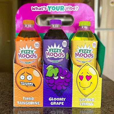 Variety pack on kitchen counter displaying the flavours Timid Tangerine, Gloomy Grape, and Loving Lemon. Tagline, 'What's your vibe?' is placed along the handle.