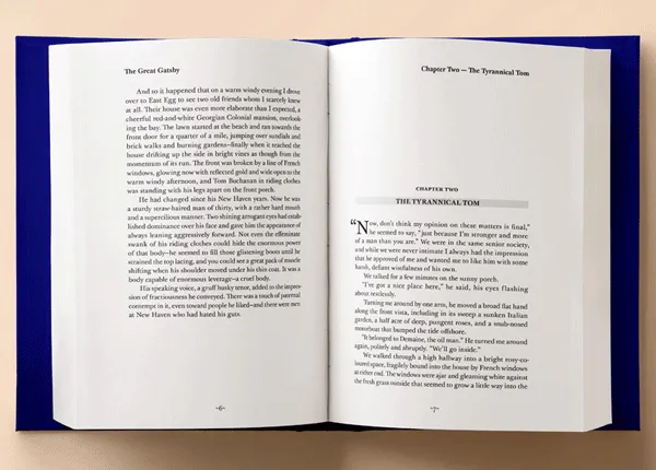 Open book on table with pages facing up revealing spread of the last page of a previous chapter on the left and the first page of the next chapter on the right.